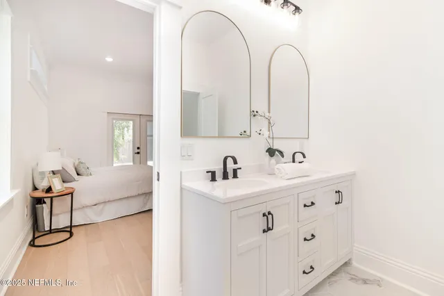 a living room with furniture and mirror