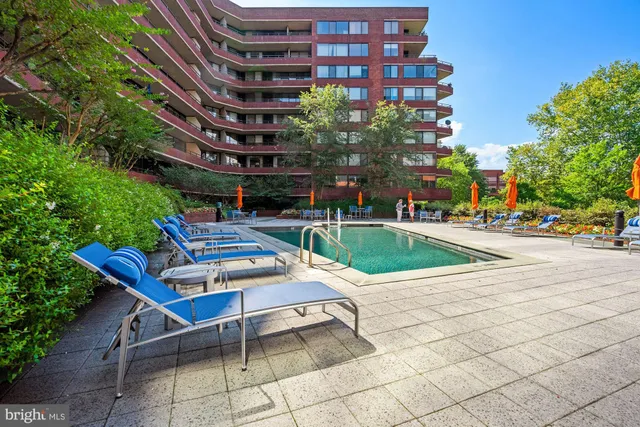 a view of a building with a window and car parked