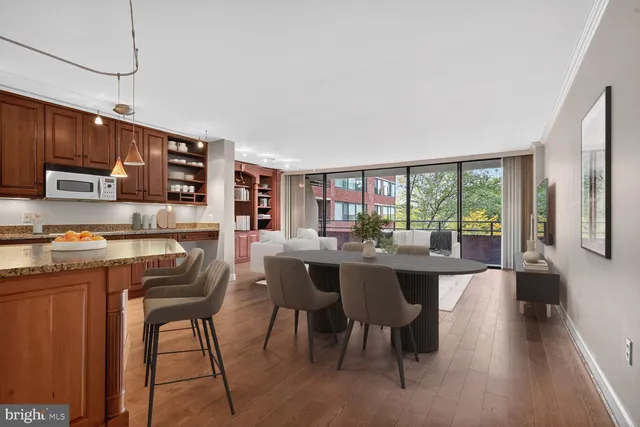a dining room with a large window table and chairs