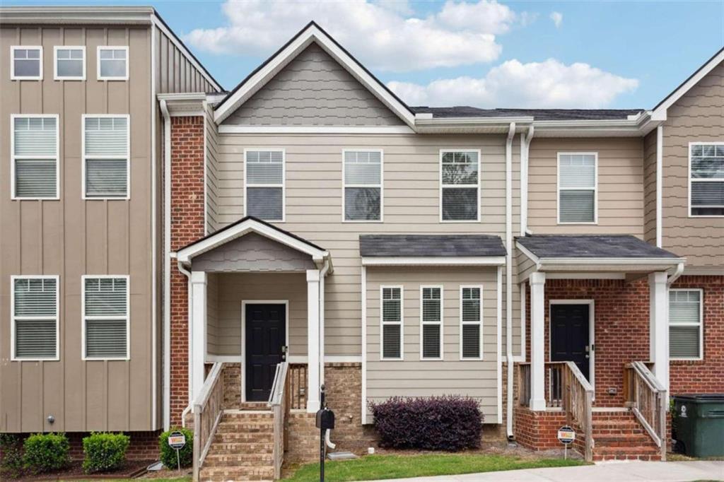 6329 Rockaway Road Atlanta, GA 30349 - Photo 1 of 1 a front view of a house with a yard