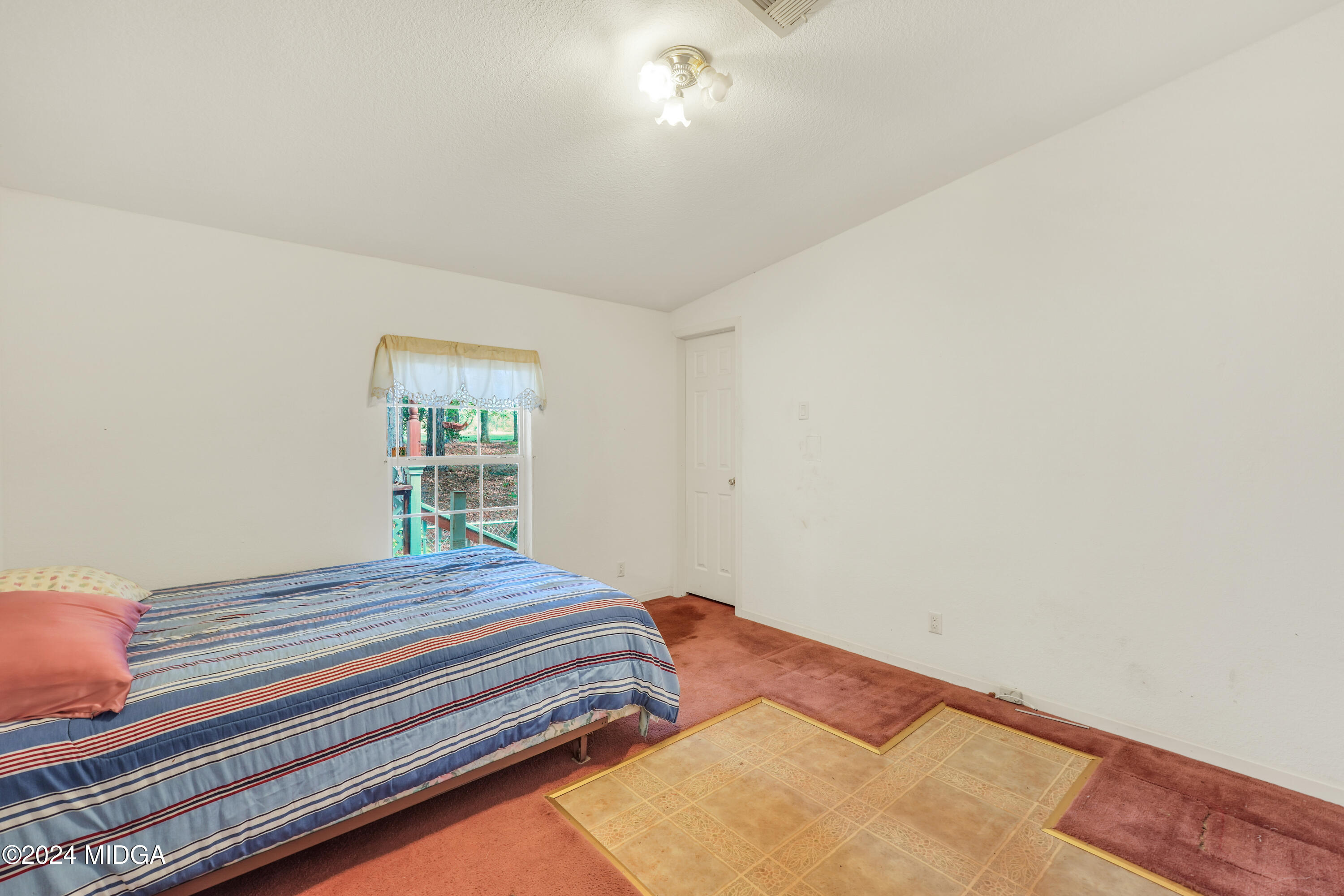 615 Fuller Road Culloden, GA 31016 - Photo 23 of 37 a bedroom with a bed and a window