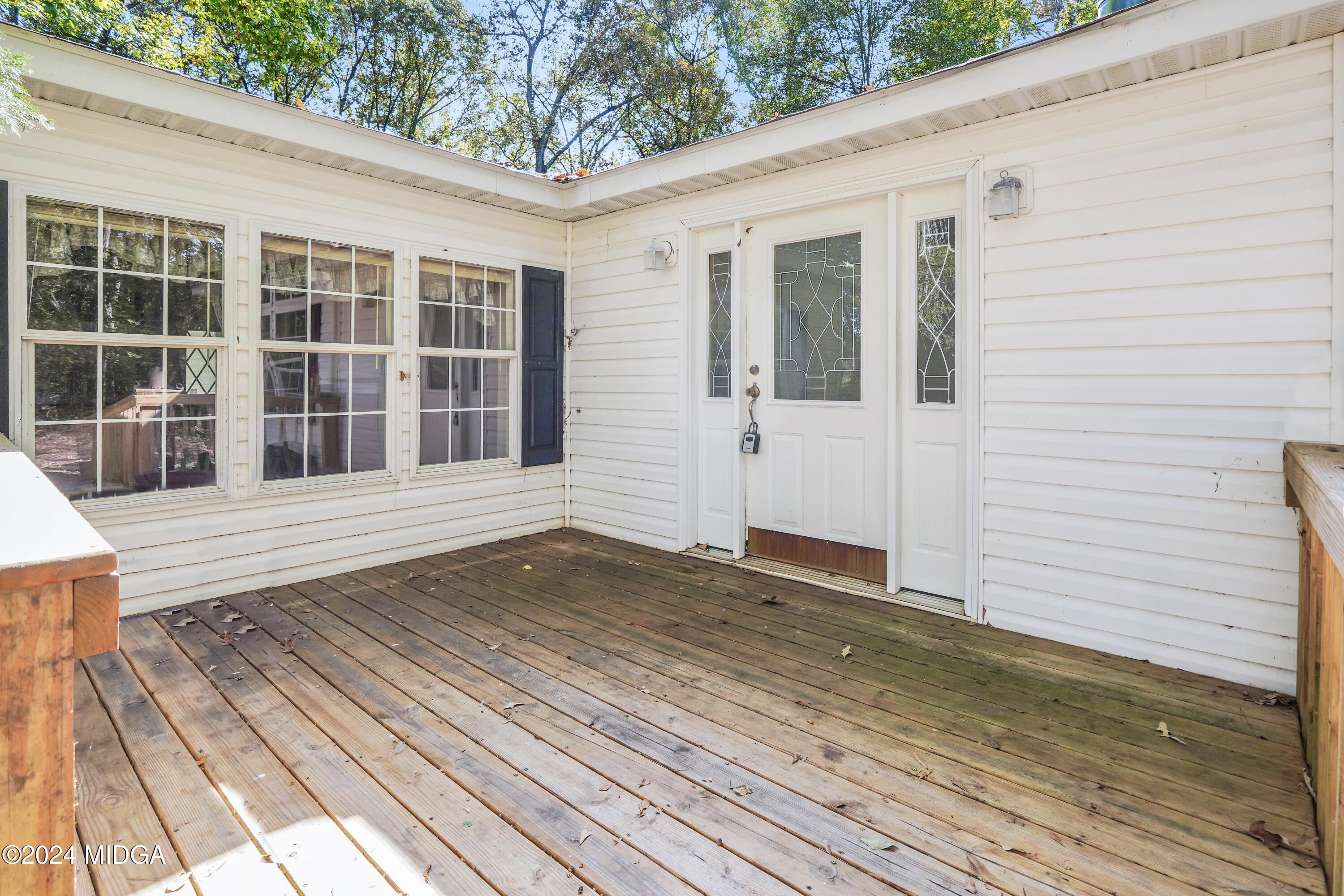 615 Fuller Road Culloden, GA 31016 - Photo 4 of 37 a view of a balcony with wooden floor and fence