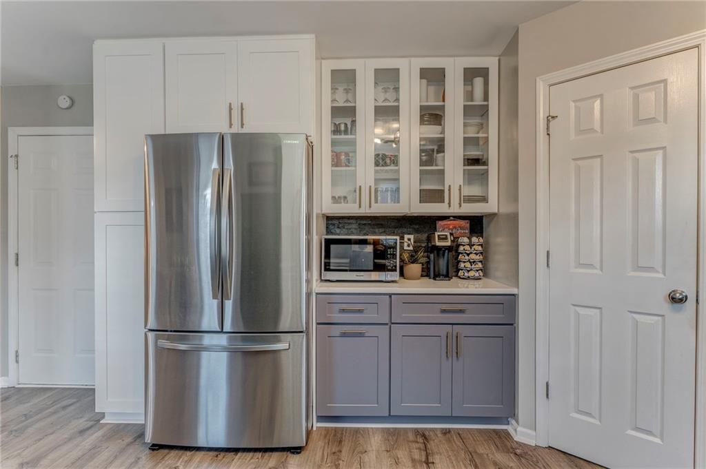 803 Riverside Drive Calhoun, GA 30701 - Photo 19 of 63 a kitchen with stainless steel appliances a refrigerator and cabinets