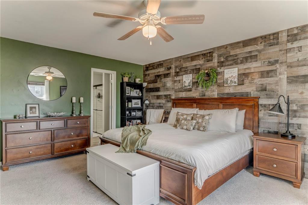 803 Riverside Drive Calhoun, GA 30701 - Photo 29 of 63 a bedroom with a large bed and a chandelier