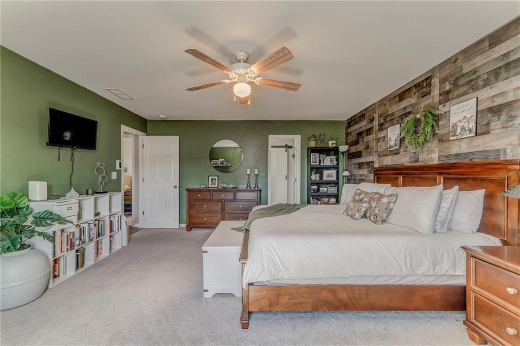 803 Riverside Drive Calhoun, GA 30701 - Photo 30 of 63 a spacious bedroom with a bed and a flat screen tv