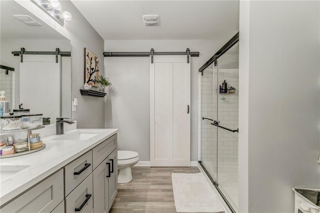 803 Riverside Drive Calhoun, GA 30701 - Photo 31 of 63 a bathroom with a sink a toilet a mirror and shower