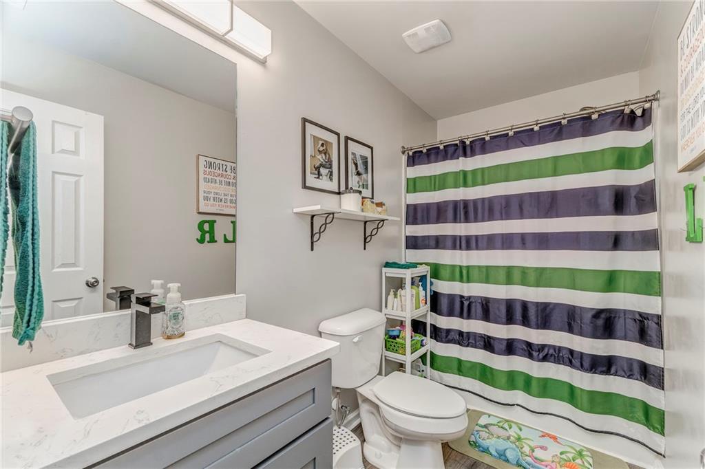 803 Riverside Drive Calhoun, GA 30701 - Photo 45 of 63 a bathroom with a sink a toilet and a shower curtain