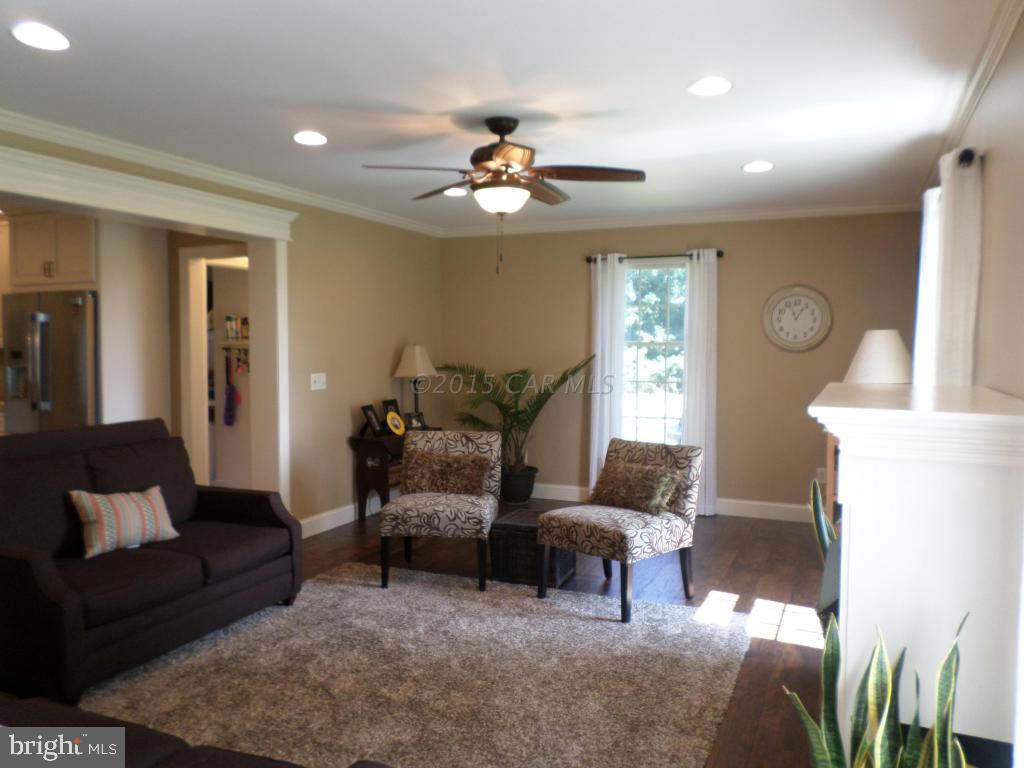 9018 Bethel Road Willards, MD 21874 - Photo 14 of 42 a living room with furniture and a chandelier