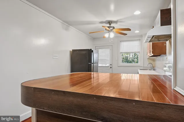 a view of kitchen and empty room