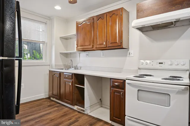 a kitchen with stainless steel appliances granite countertop a stove and a refrigerator