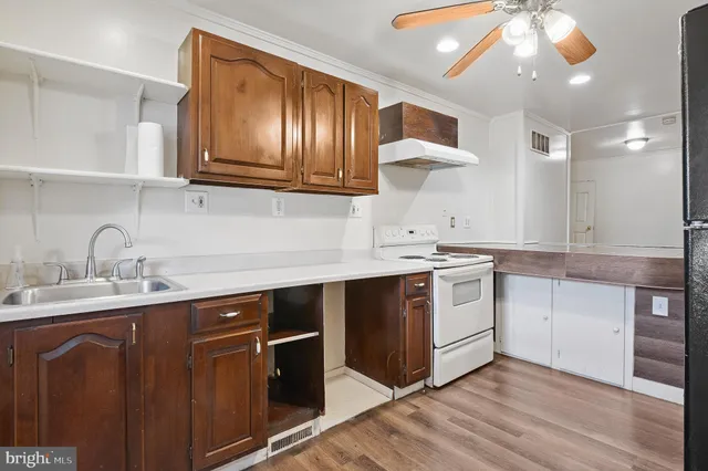 a kitchen with a sink cabinets and stainless steel appliances