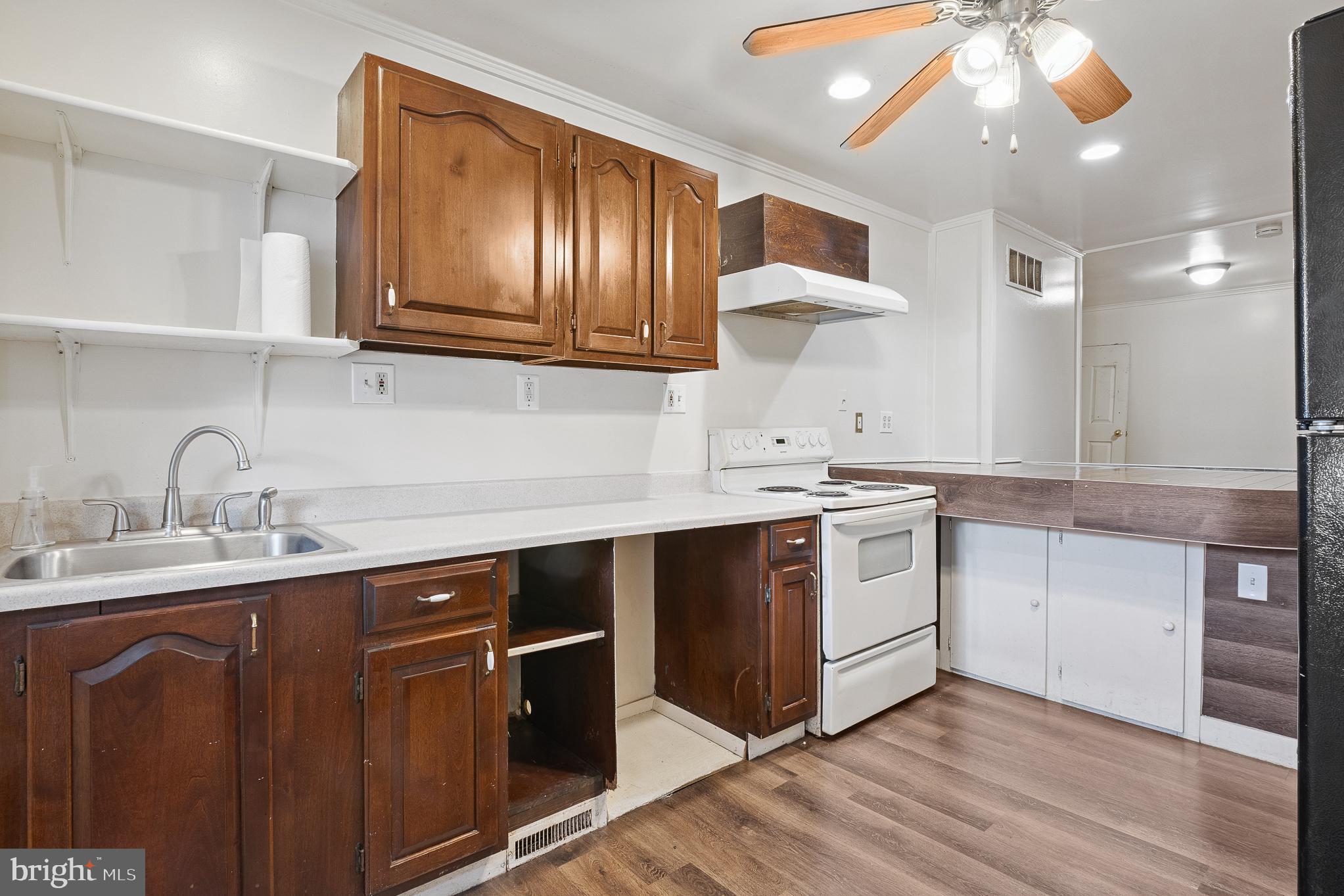 636 South Monroe Street Baltimore, MD 21223 - Photo 16 of 39 a kitchen with a sink cabinets and stainless steel appliances