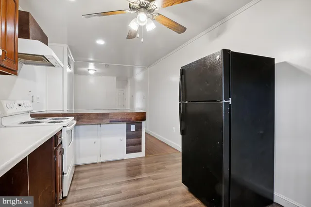 a kitchen with a refrigerator and a sink