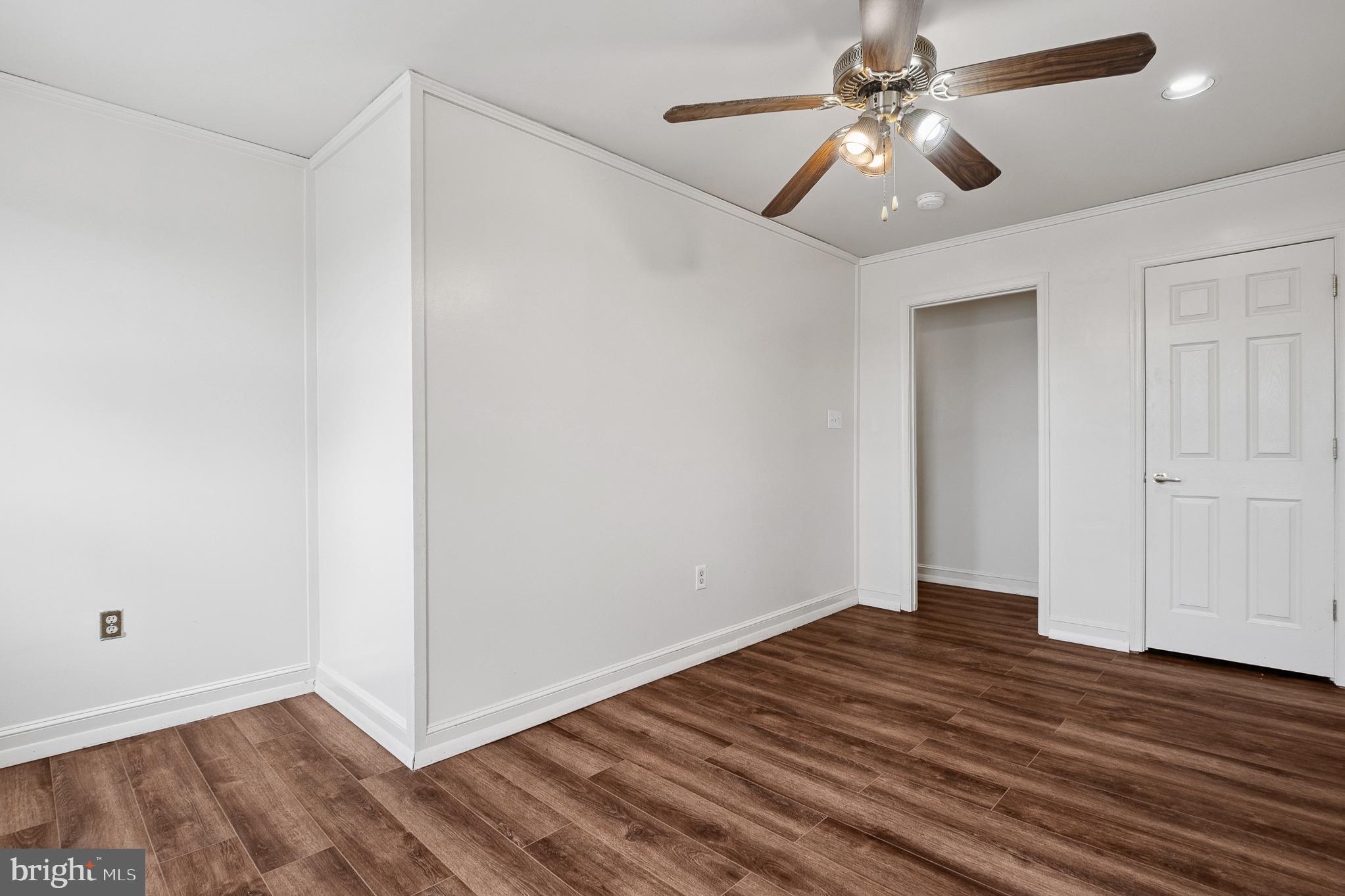 636 South Monroe Street Baltimore, MD 21223 - Photo 21 of 39 an empty room with wooden floor fan and windows