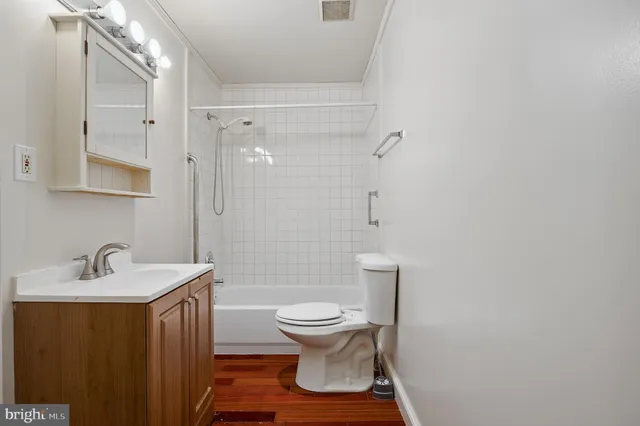a bathroom with a sink toilet a mirror and shower