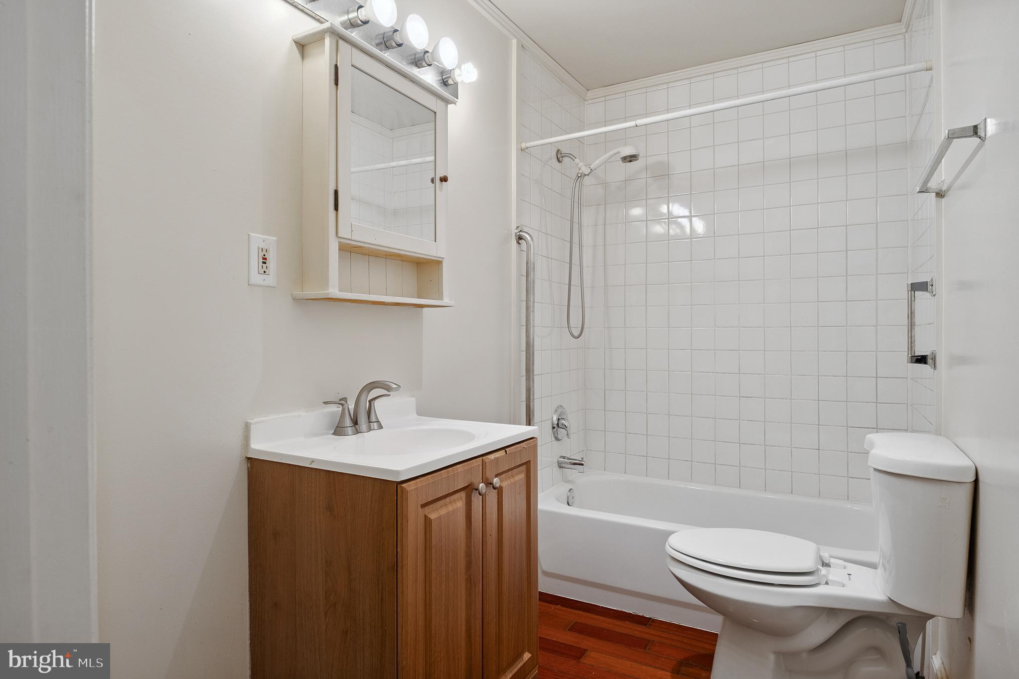 636 South Monroe Street Baltimore, MD 21223 - Photo 25 of 39 a bathroom with a sink toilet a mirror and shower