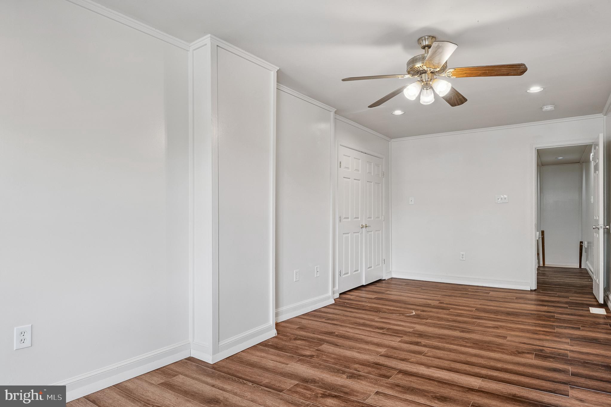 636 South Monroe Street Baltimore, MD 21223 - Photo 29 of 39 a view of a room with wooden floor and ceiling fan