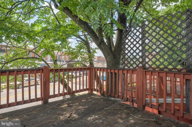 a view of backyard with wooden fence