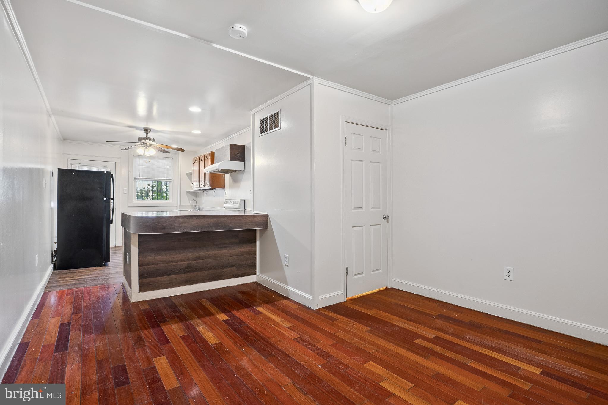 636 South Monroe Street Baltimore, MD 21223 - Photo 7 of 39 a view of kitchen and hallway with wooden floor