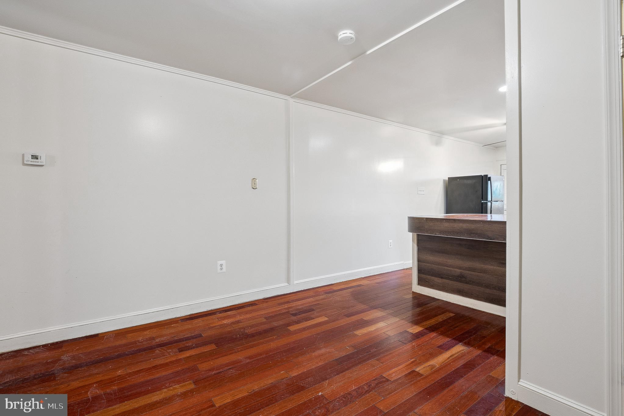 636 South Monroe Street Baltimore, MD 21223 - Photo 8 of 39 a view of an empty room with wooden floor