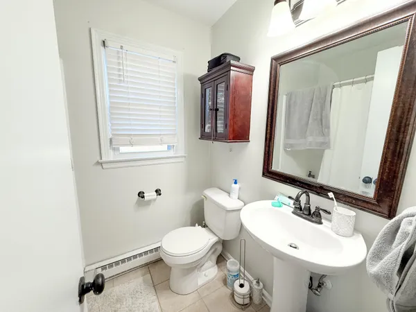 a bathroom with a sink a toilet and mirror