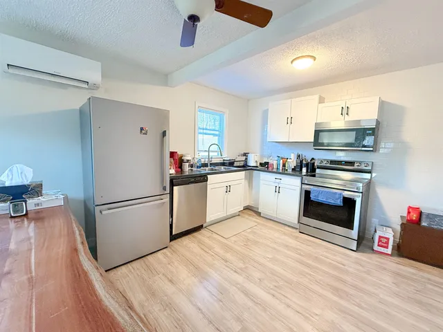 a kitchen with a sink a refrigerator and a stove