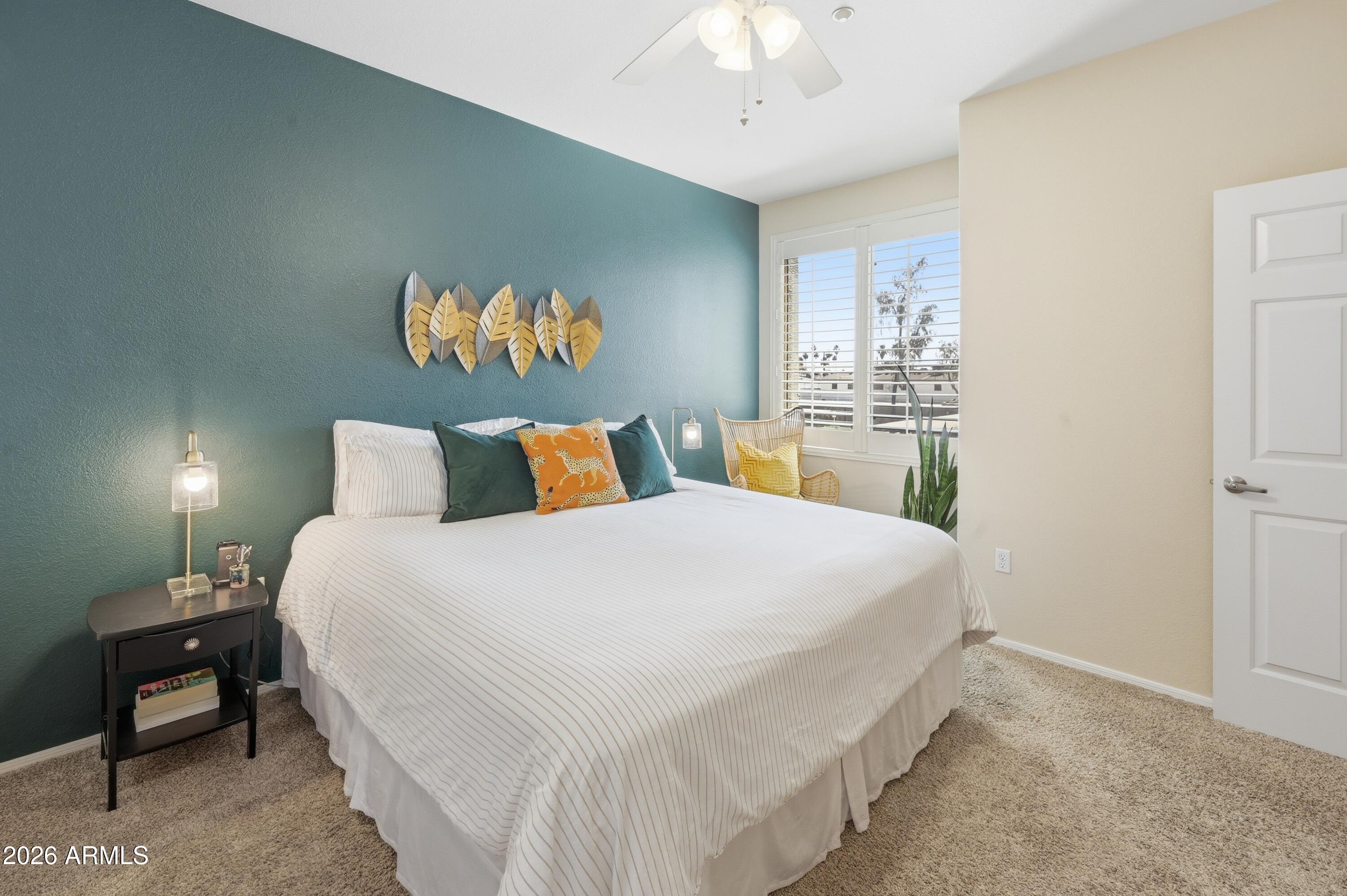 5303 North 7th Street, Unit 220 Phoenix, AZ 85014 - Photo 17 of 33 a bedroom with a bed and a chandelier