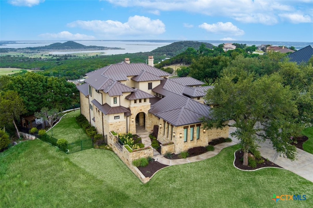 an aerial view of a house with garden space and street view