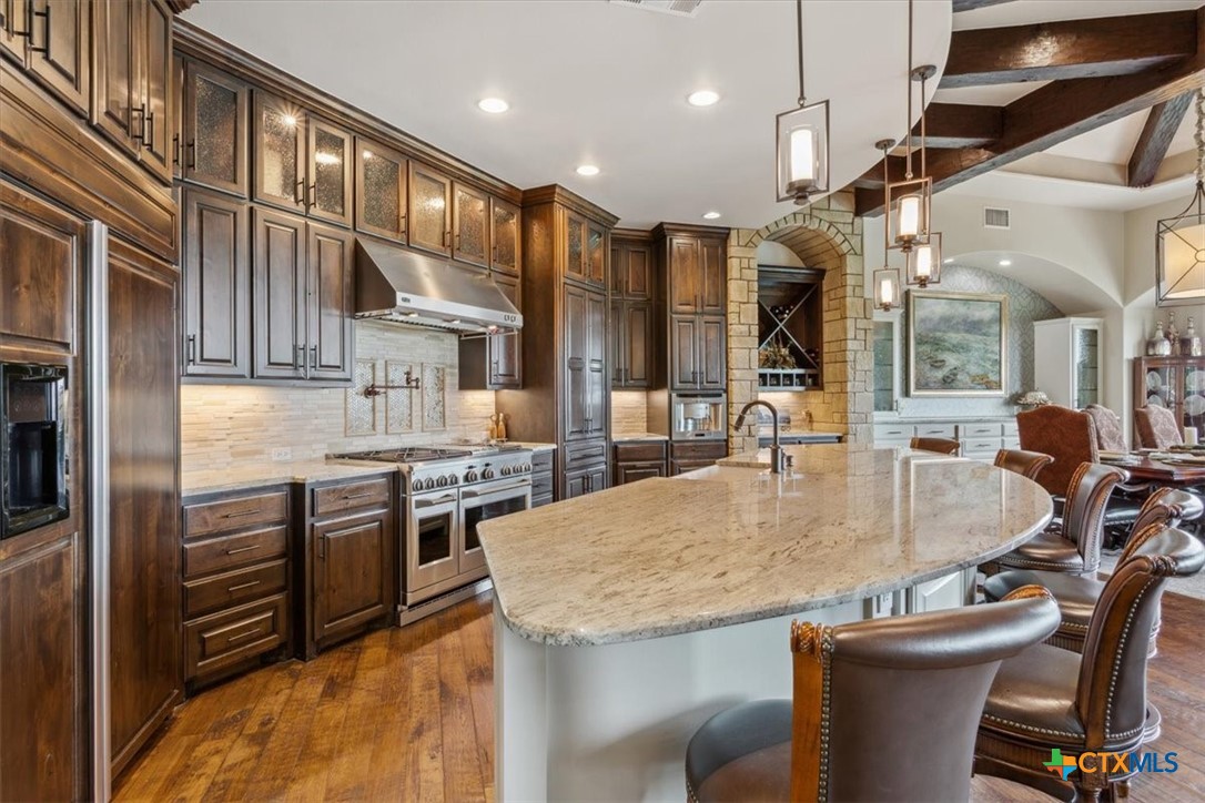3319 Eagle Ridge Drive Harker Heights, TX 76548 - Photo 13 of 48 a kitchen with stainless steel appliances granite countertop a sink and a refrigerator
