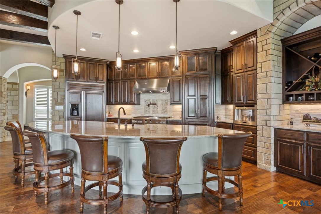 3319 Eagle Ridge Drive Harker Heights, TX 76548 - Photo 14 of 48 a kitchen with kitchen island stainless steel appliances a dining table and chairs