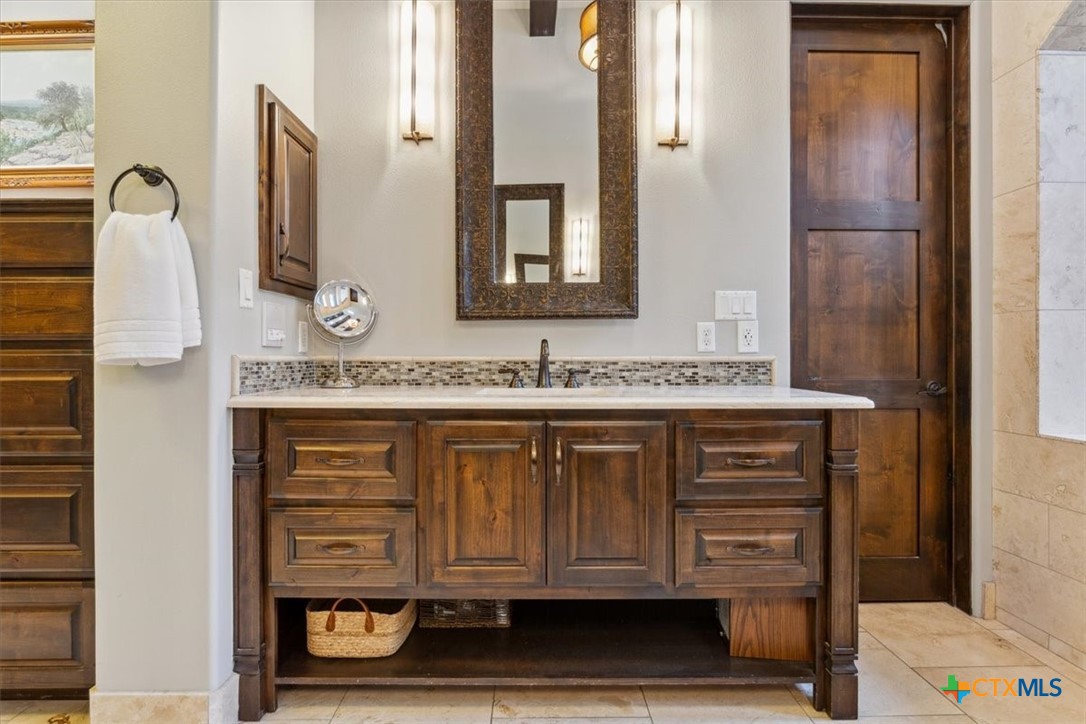 3319 Eagle Ridge Drive Harker Heights, TX 76548 - Photo 20 of 48 a bathroom with a granite countertop sink and a mirror