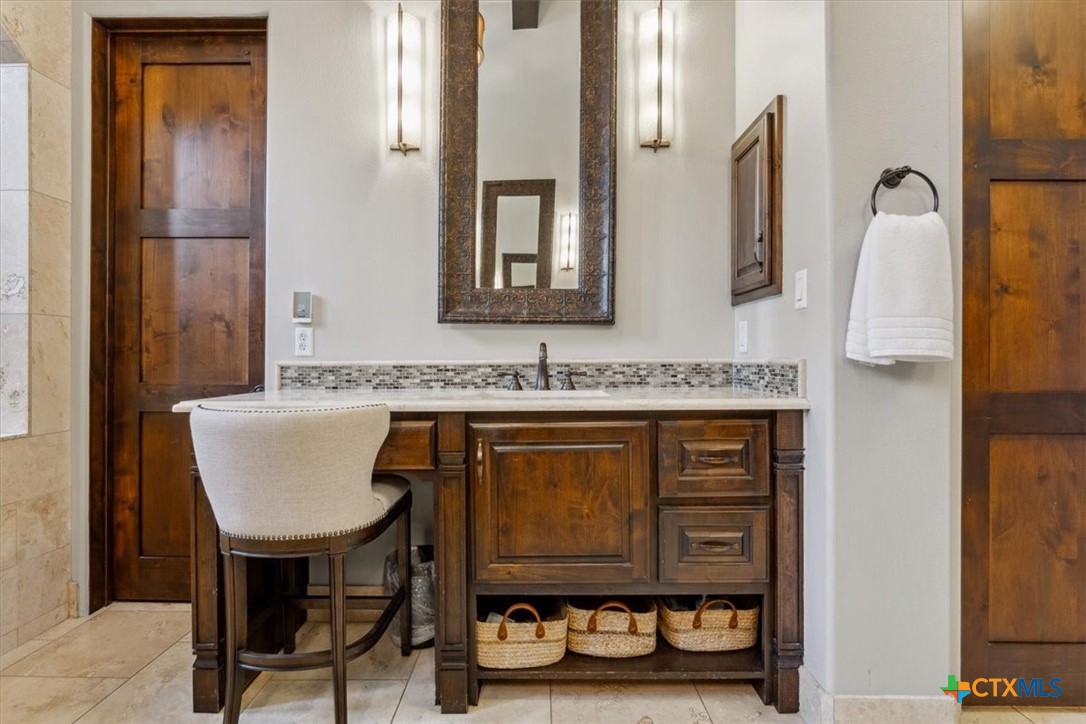 3319 Eagle Ridge Drive Harker Heights, TX 76548 - Photo 21 of 48 a bathroom with a granite countertop sink and a mirror
