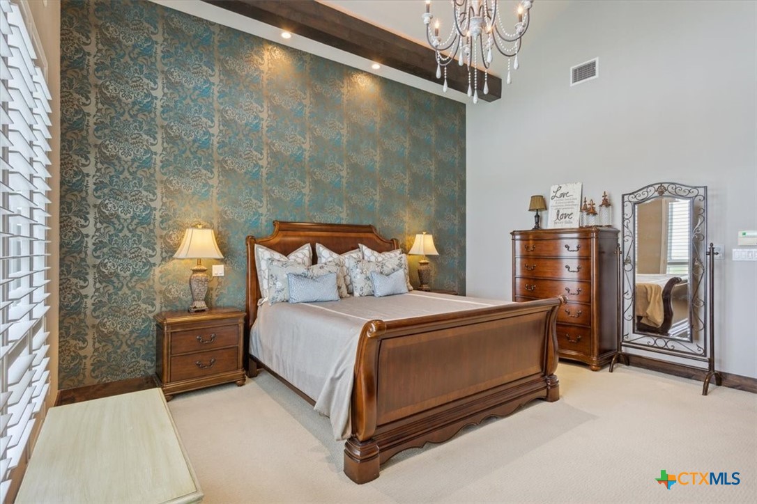 3319 Eagle Ridge Drive Harker Heights, TX 76548 - Photo 24 of 48 a bedroom with a bed and a chandelier