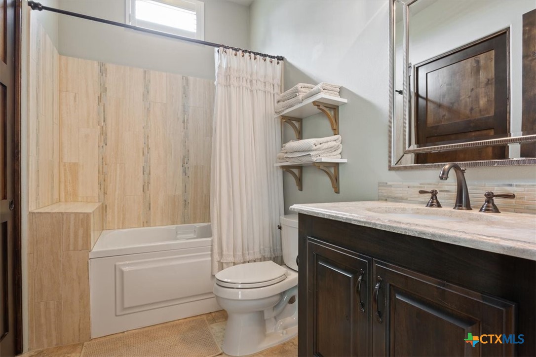 3319 Eagle Ridge Drive Harker Heights, TX 76548 - Photo 31 of 48 a bathroom with a granite countertop sink toilet and mirror