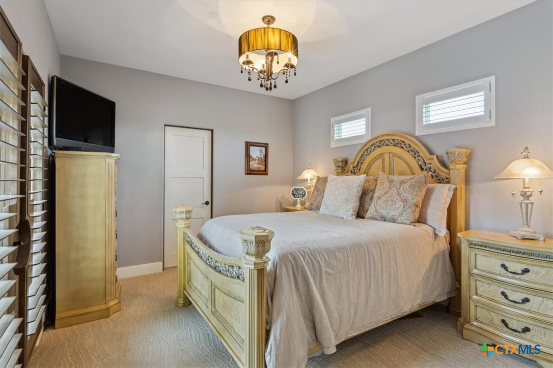 3319 Eagle Ridge Drive Harker Heights, TX 76548 - Photo 37 of 48 a spacious bedroom with a bed and a chandelier