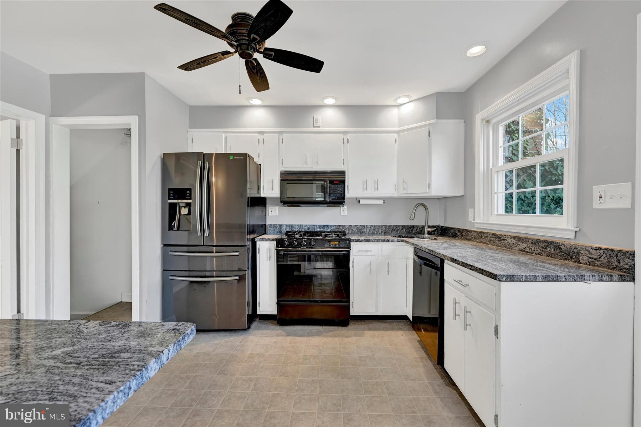 8122 Glen Gary Road Towson, MD 21286 - Photo 14 of 48 a kitchen with stainless steel appliances granite countertop a refrigerator and a stove top oven
