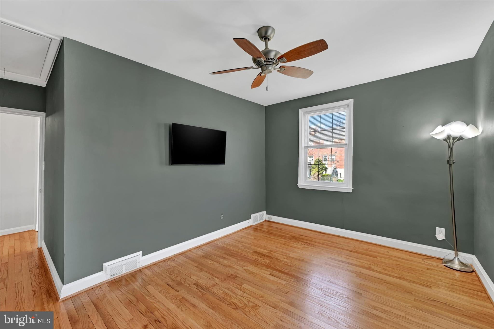 8122 Glen Gary Road Towson, MD 21286 - Photo 25 of 48 a view of a livingroom with wooden floor and a ceiling fan