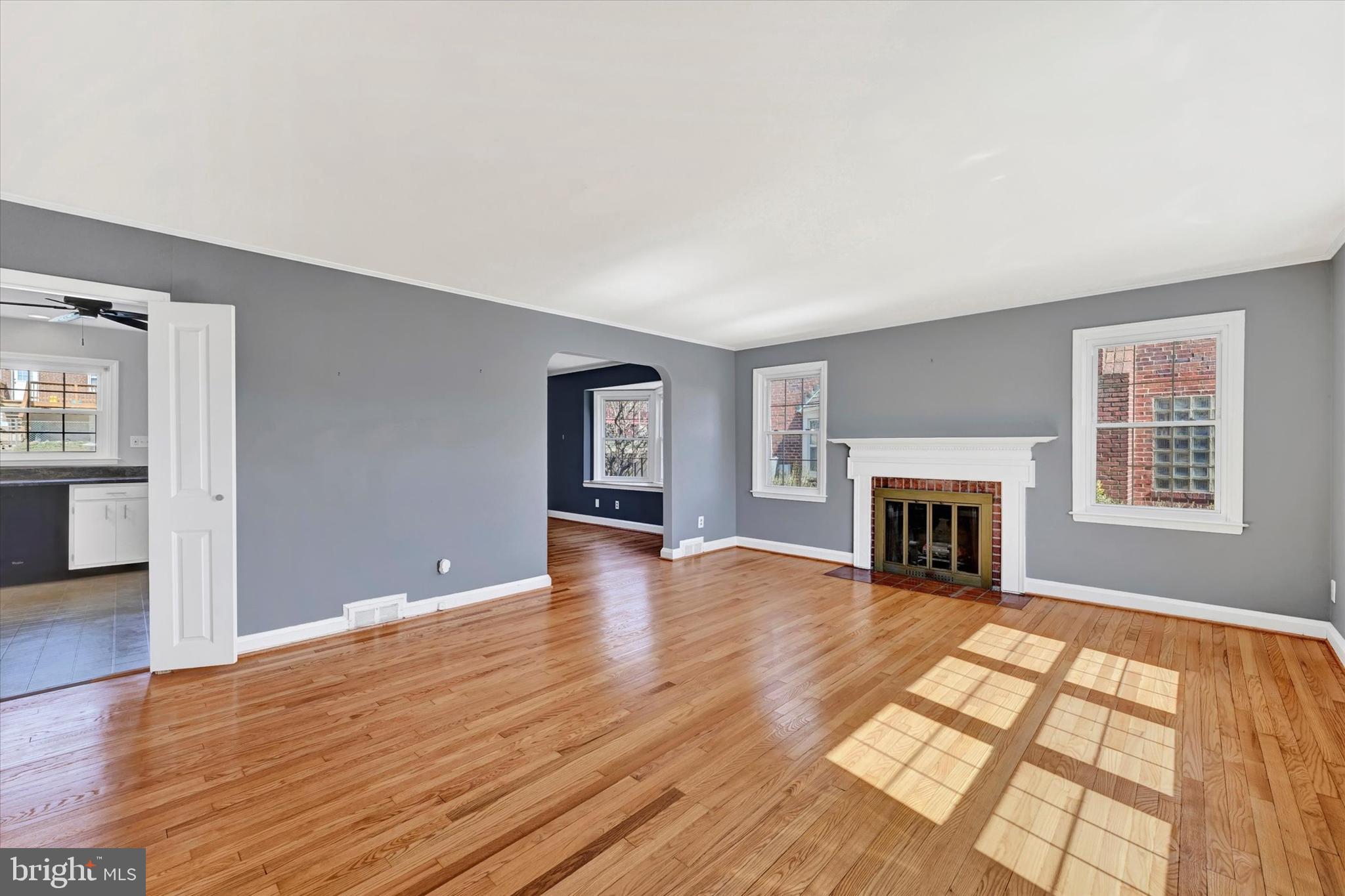 8122 Glen Gary Road Towson, MD 21286 - Photo 7 of 48 a view of empty room with wooden floor and fireplace