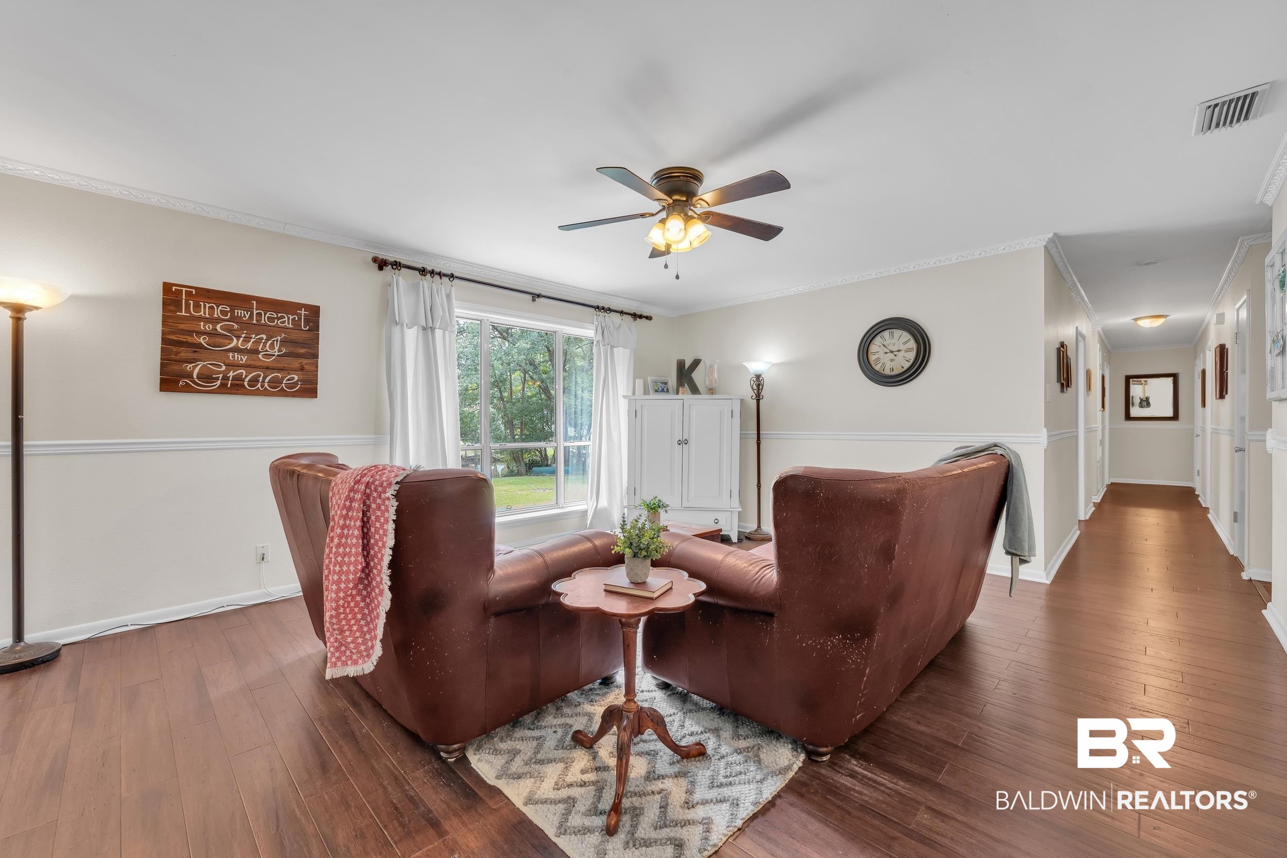 224 Cache Circle Mobile, AL 36611 - Photo 7 of 42 Living area with a ceiling fan, ornamental molding, and hardwood / wood-style flooring