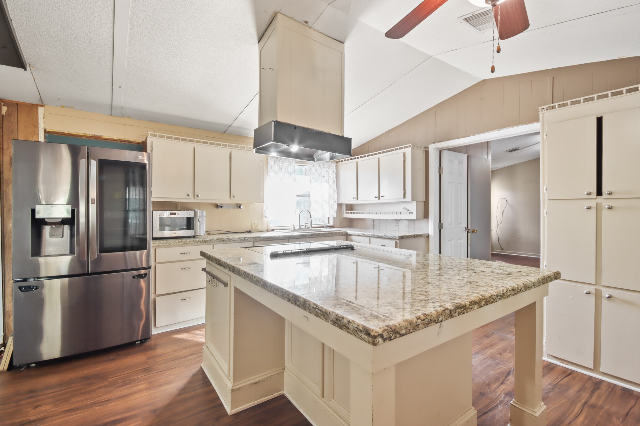 a kitchen with stainless steel appliances granite countertop a refrigerator a sink and a stove