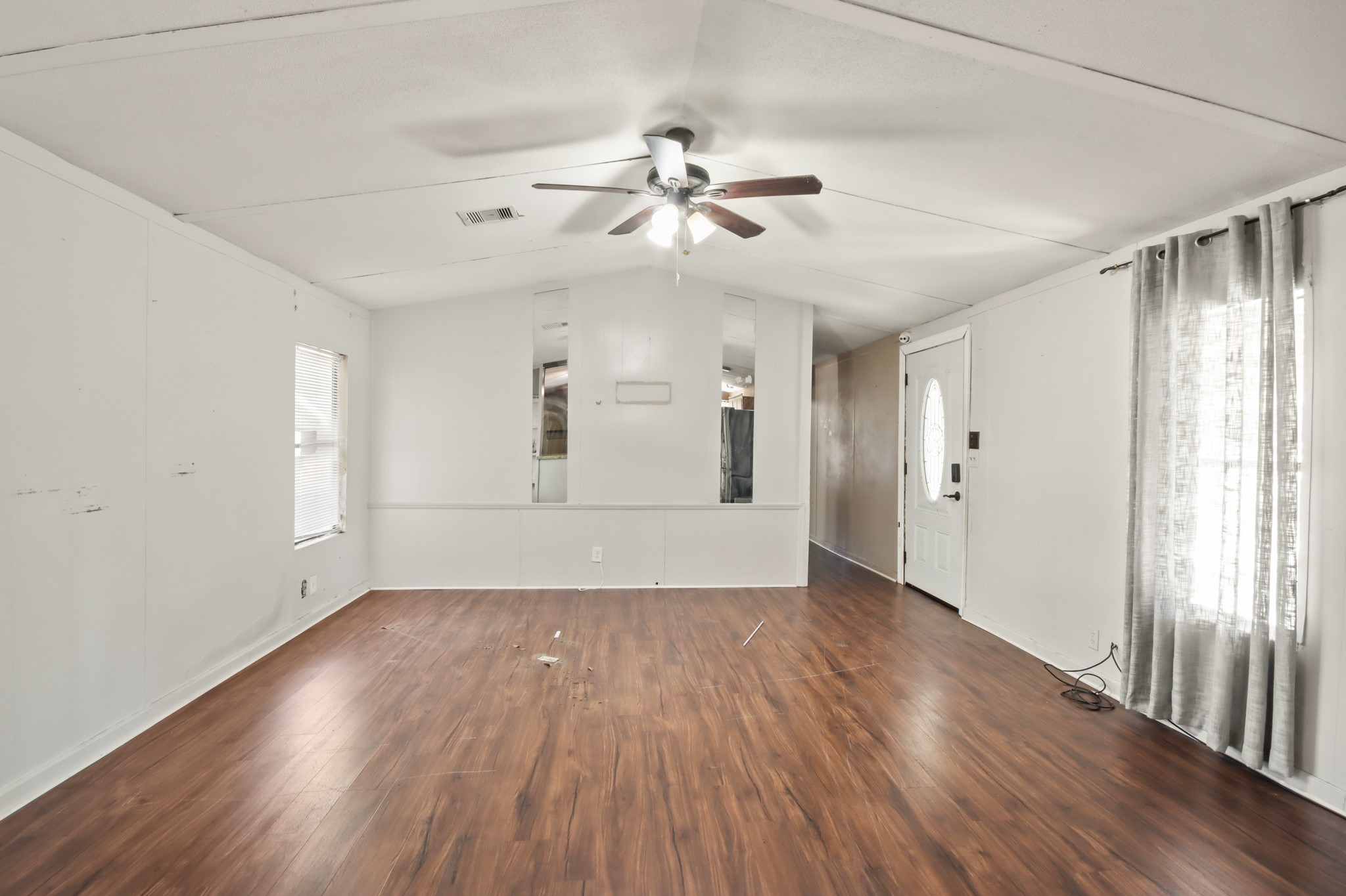 17317 East Greenleaf Lane Conroe, TX 77306 - Photo 6 of 24 a view of an empty room with wooden floor and a window