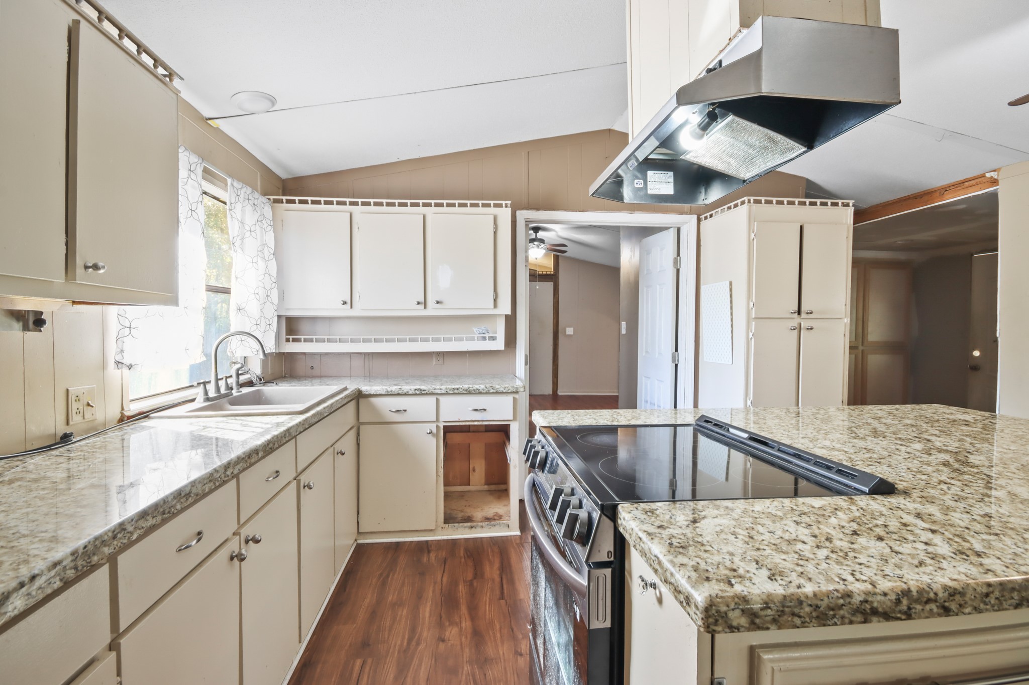 17317 East Greenleaf Lane Conroe, TX 77306 - Photo 7 of 24 a kitchen with stainless steel appliances granite countertop a sink window and cabinets