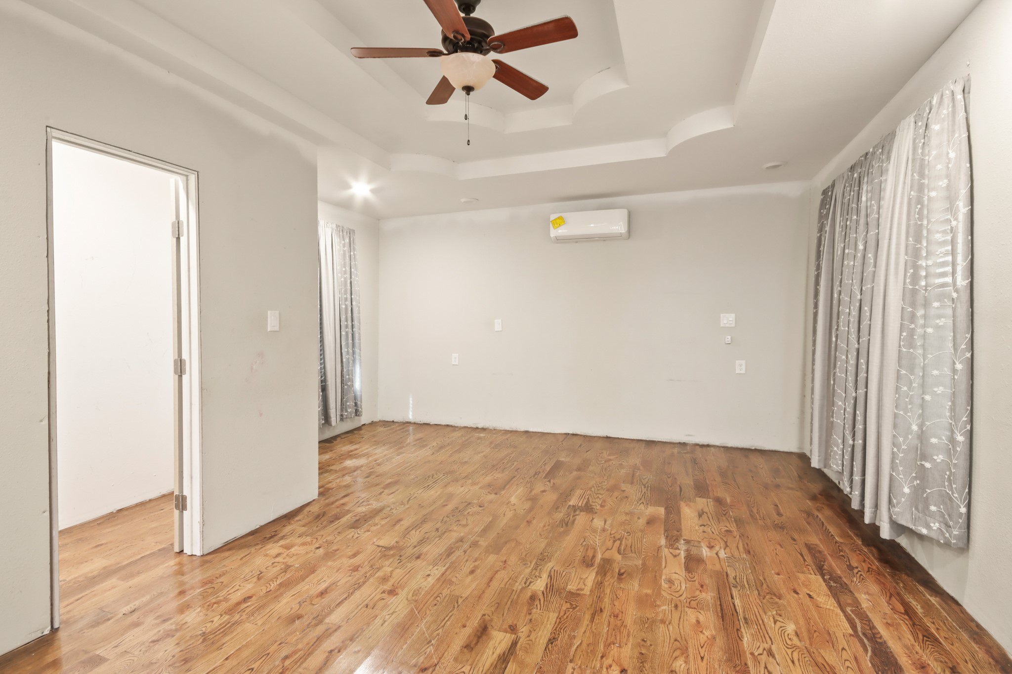 17317 East Greenleaf Lane Conroe, TX 77306 - Photo 10 of 24 a view of empty room with wooden floor and fan
