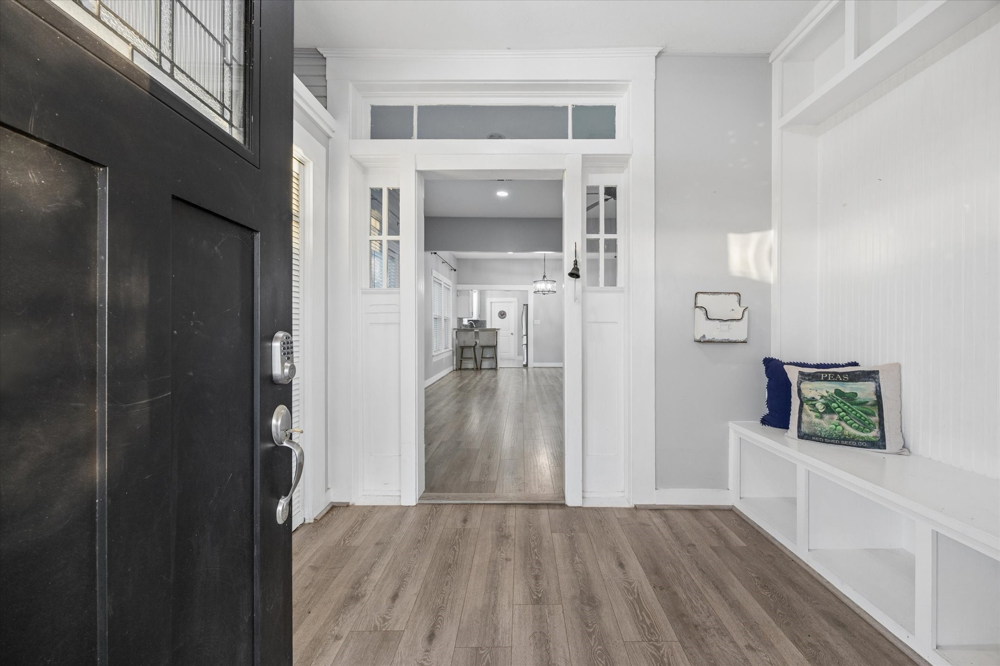 10347 Pless Road Cat Spring, TX 78933 - Photo 4 of 41 Welcome to a bright, inviting entryway with modern light fixtures, and a cozy built-in bench. The open layout leads seamlessly into the main living area, offering a warm and welcoming first impression.