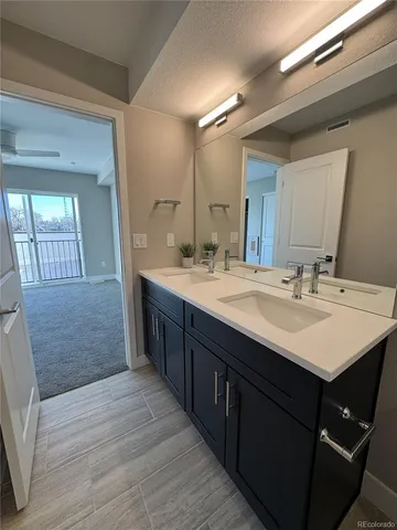 a bathroom with a double vanity sink and a mirror