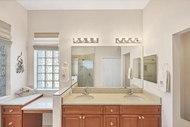 an aerial view of a city with lots of residential buildings and ocean view in back