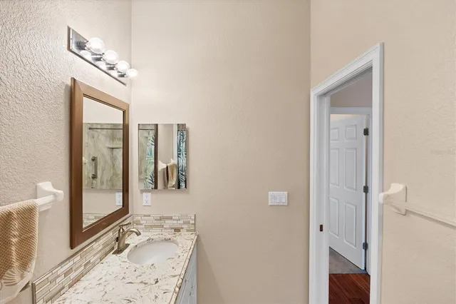 an aerial view of a house with a garden and lake view