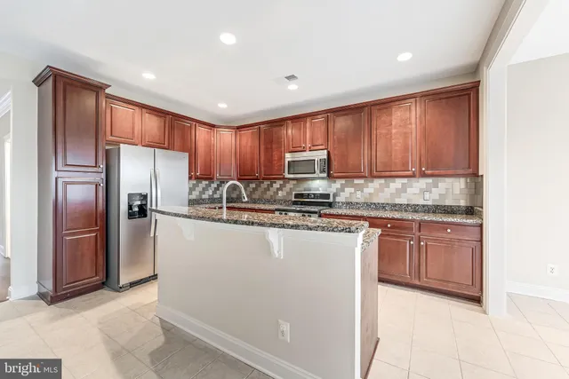 a large kitchen with granite countertop lots of counter top space