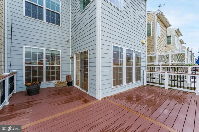 a view of a balcony with a floor to ceiling window and wooden floor