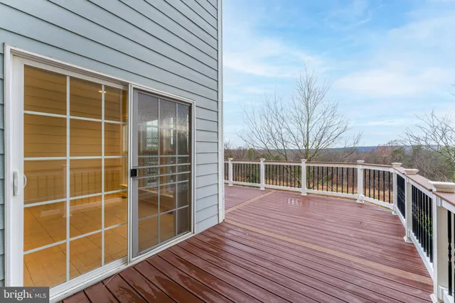 a view of balcony with wooden floor and fence